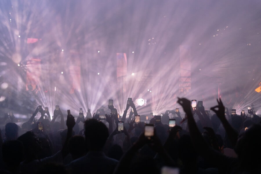 Flashing lights of a concert with people's phones in the air